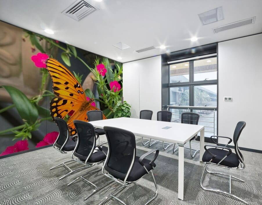 A room with a white table and black chairs