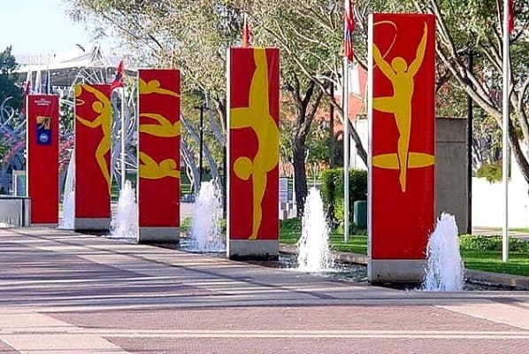 A row of red and yellow flags with people in the middle.